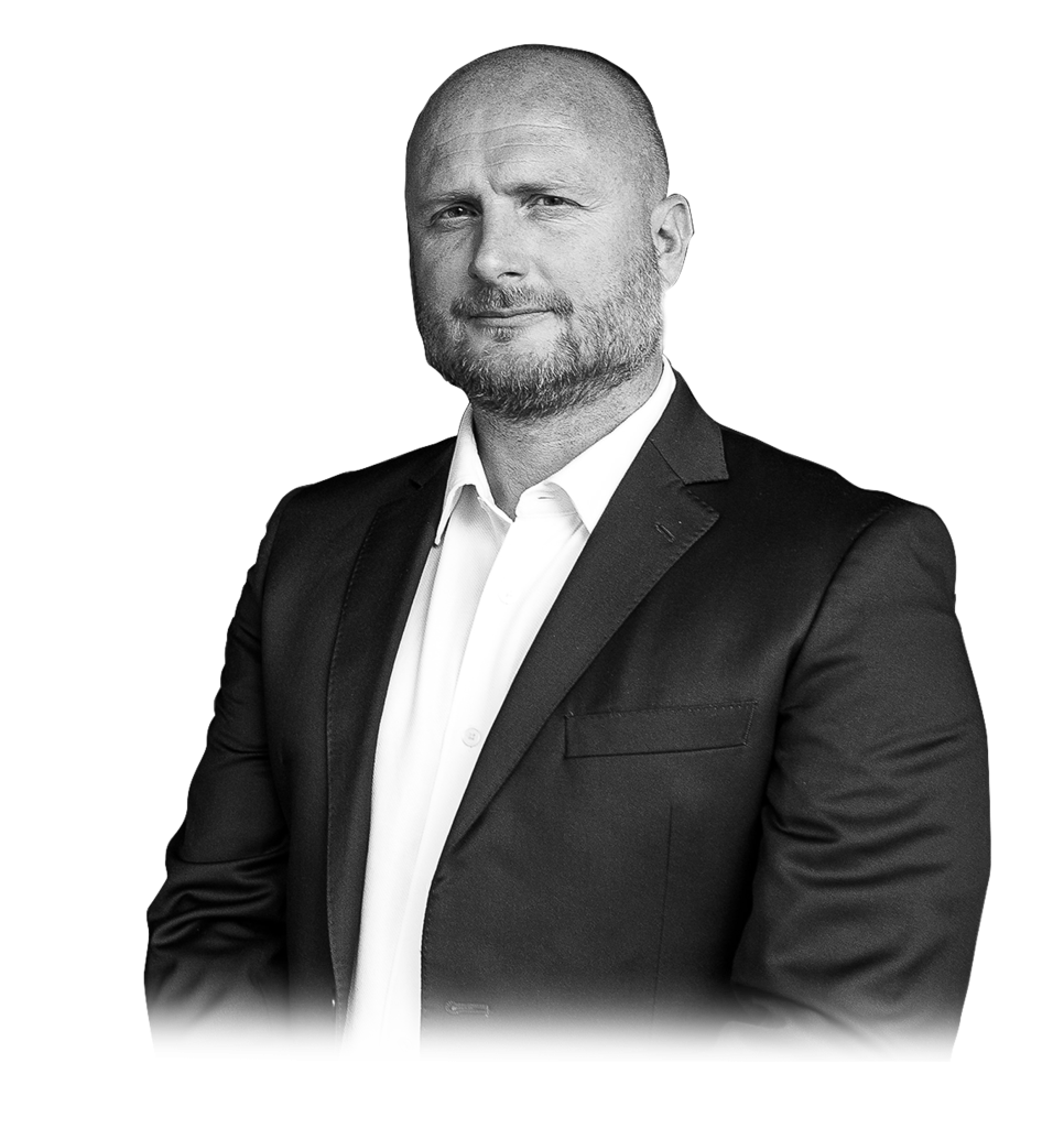 Professional portrait of a man in a suit, arms crossed, black and white photography.